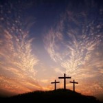 three crosses on a hill with feathered clouds
