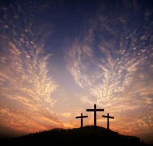 three crosses on a hill with feathered clouds