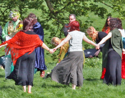 Photo of Wiccans performing a handfasting ceremony outdoors