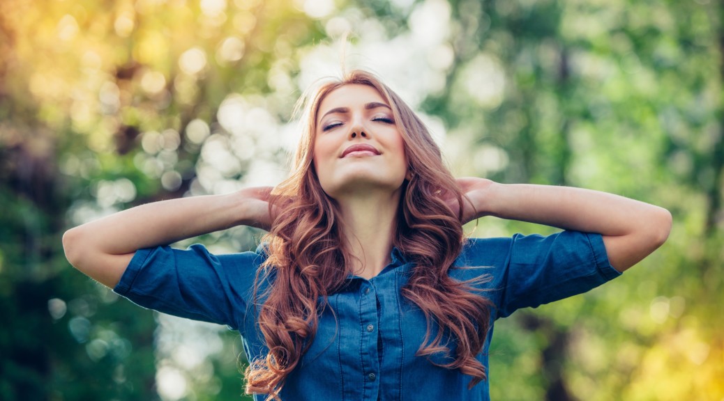 Woman expressing happiness in the woods