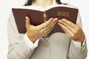 Woman holding a Holy Bible open to read