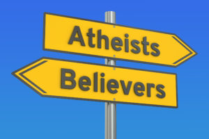 A street sign showing the way to "atheists" and "Believers".