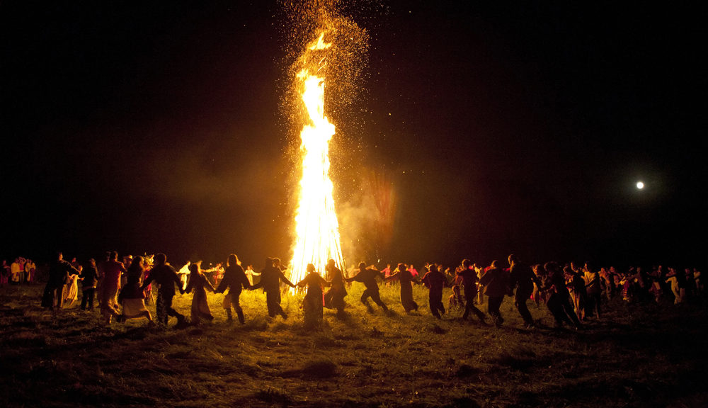 A group of pagans dancing in the summer night.