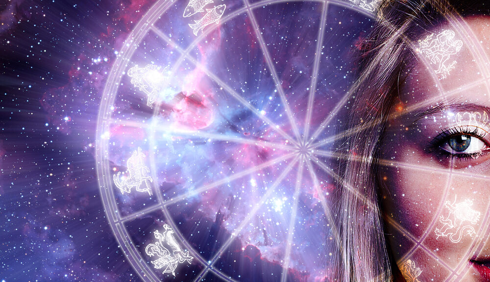 A woman set against a galaxy examines an astrology chart