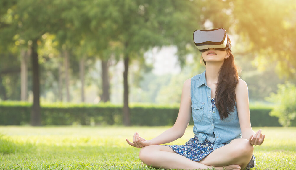 A young woman plays video games on her VR headset.