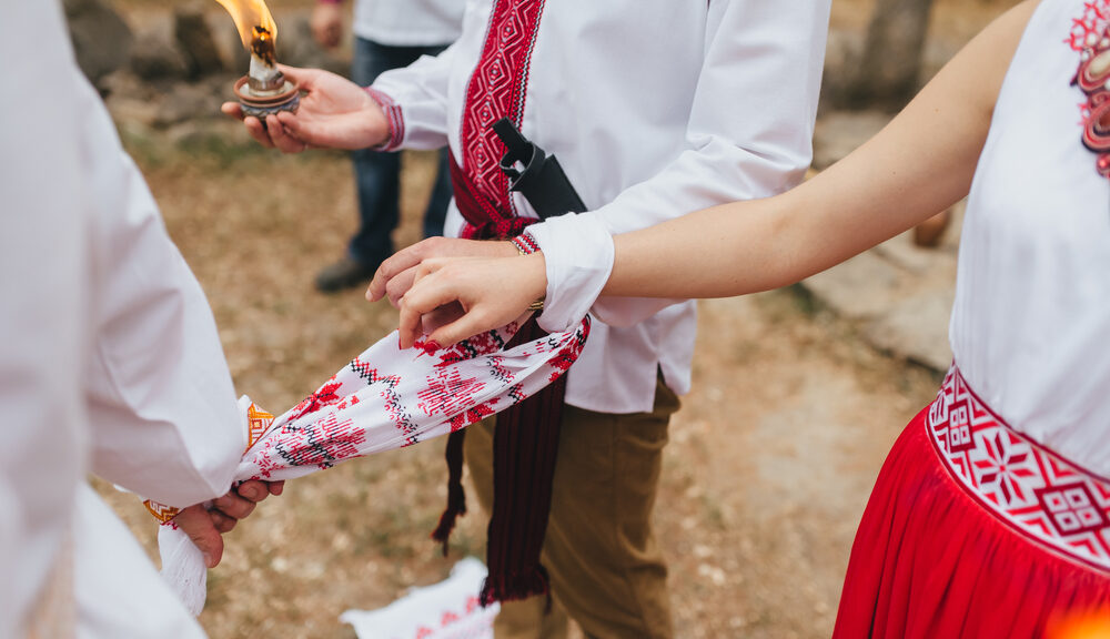 A couple goes through a handfasting ceremony.