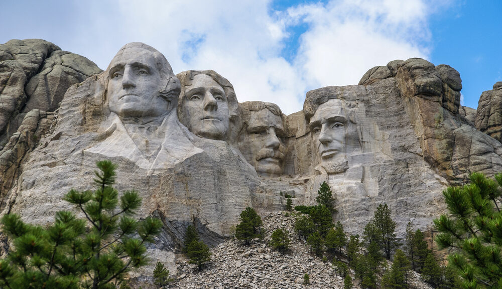 A picture of Mount Rushmore on a mostly sunny day.