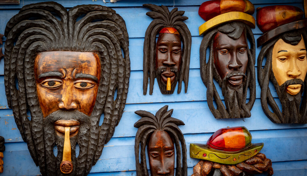 The traditional dreadlocks of Rastafari captured in a wooden mask.