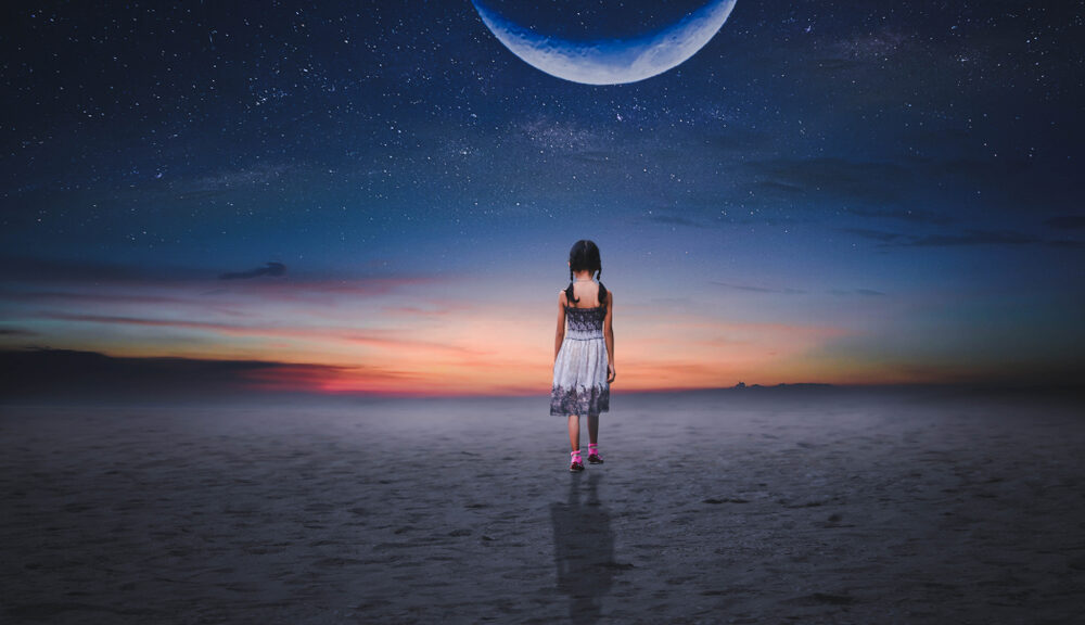 A little girl walks toward the moon.