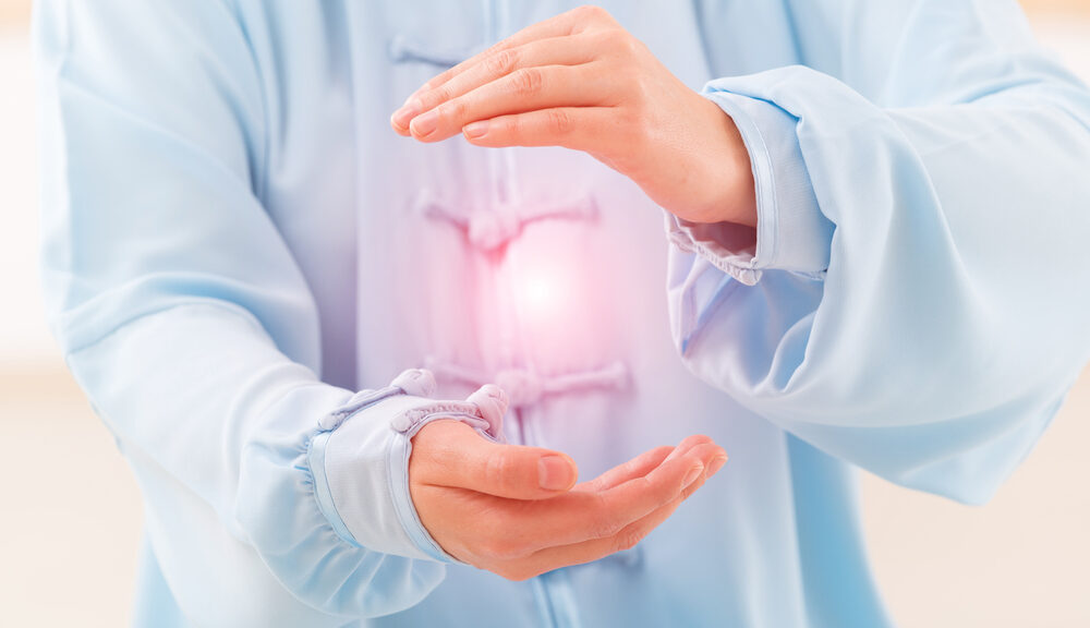 A person holds an orb of light between their hands.