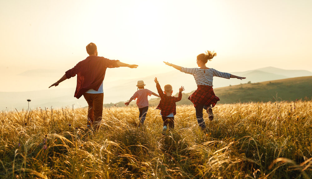 family running through meadow seeking spiritual balance