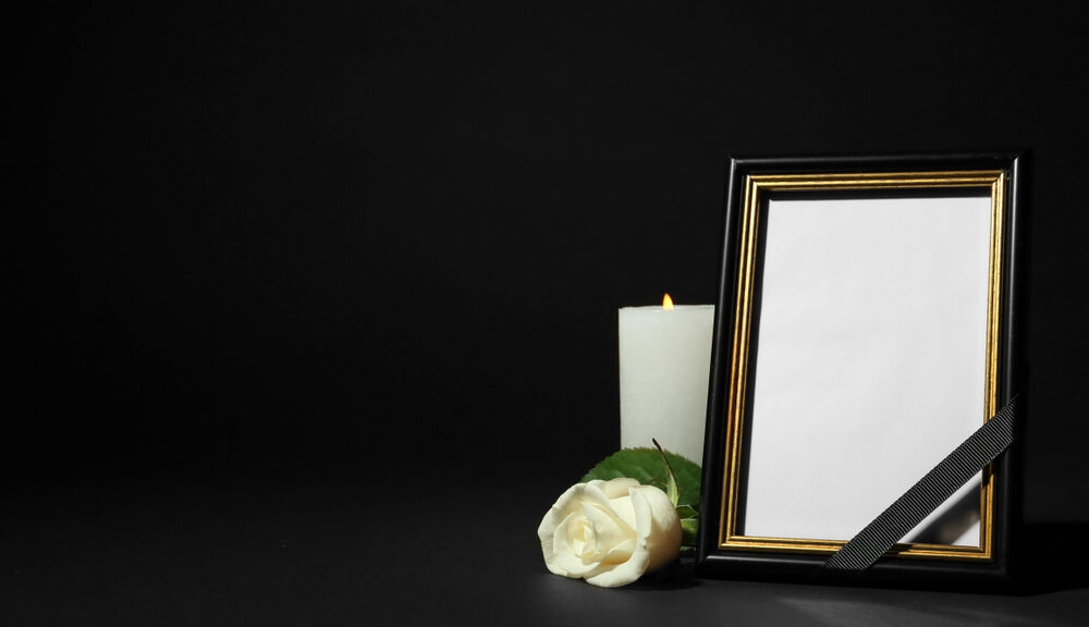 A candle, mirror and flower lay on the ground. Items required for secular funeral traditions perhaps?